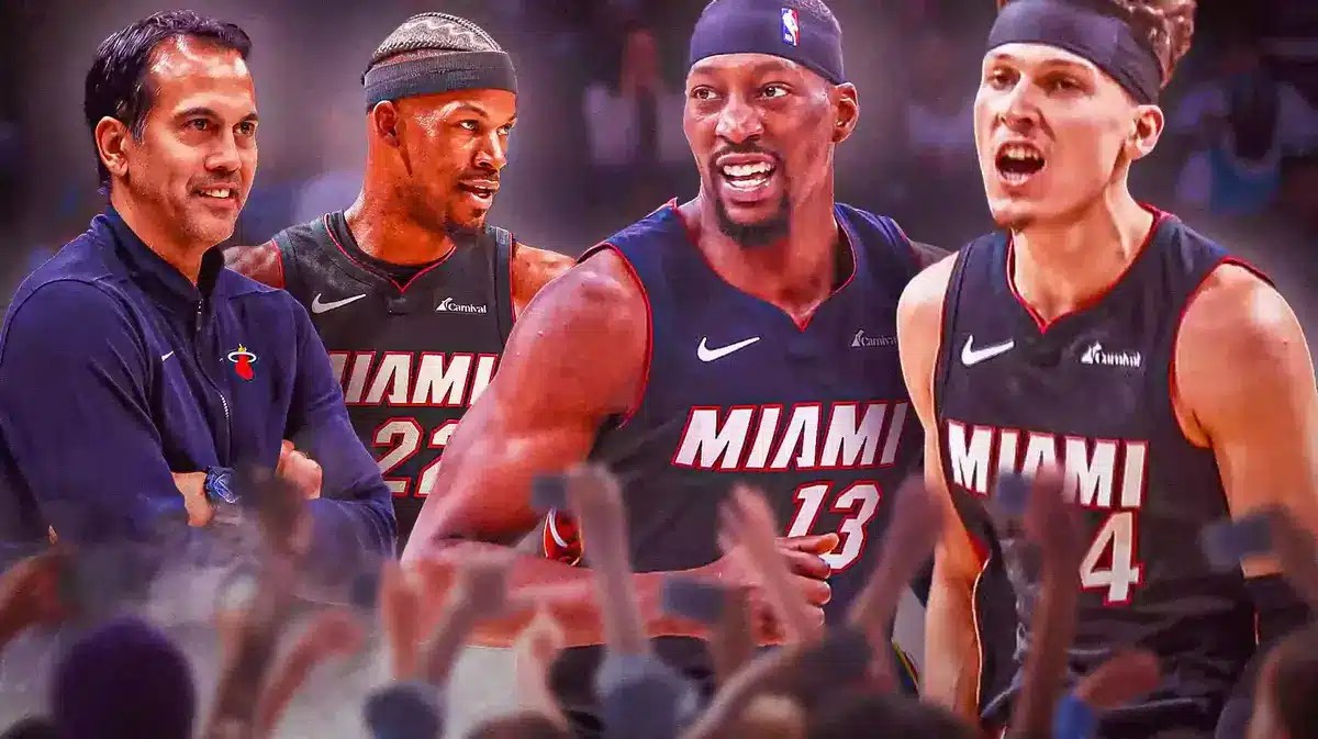 Miami Heat's Erik Spoelstra and Jimmy Butler smiling at Bam Adebayo and Tyler Herro.