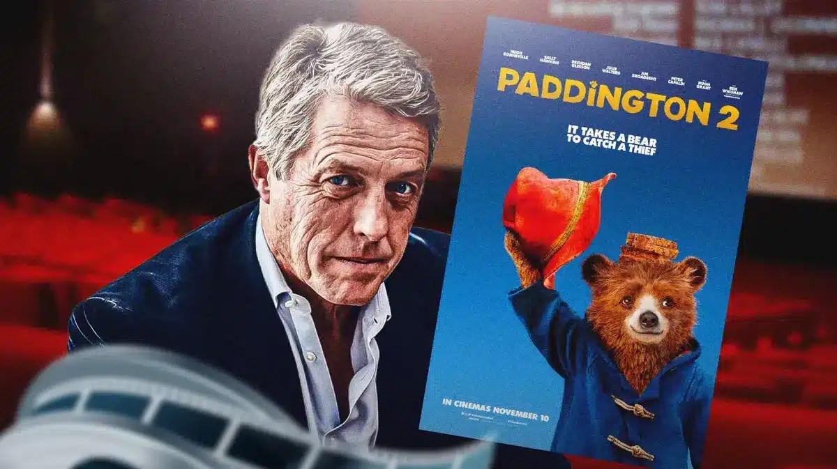 Hugh Grant next to Paddington 2 poster.