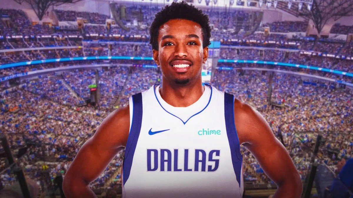 Brandon Williams in a Mavs jersey with the Mavs arena in the background
