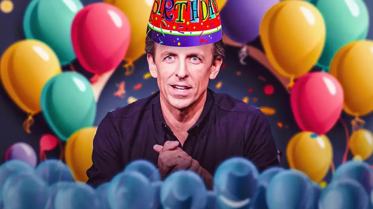 Seth Meyers wearing a birthday hat surrounded by balloons.