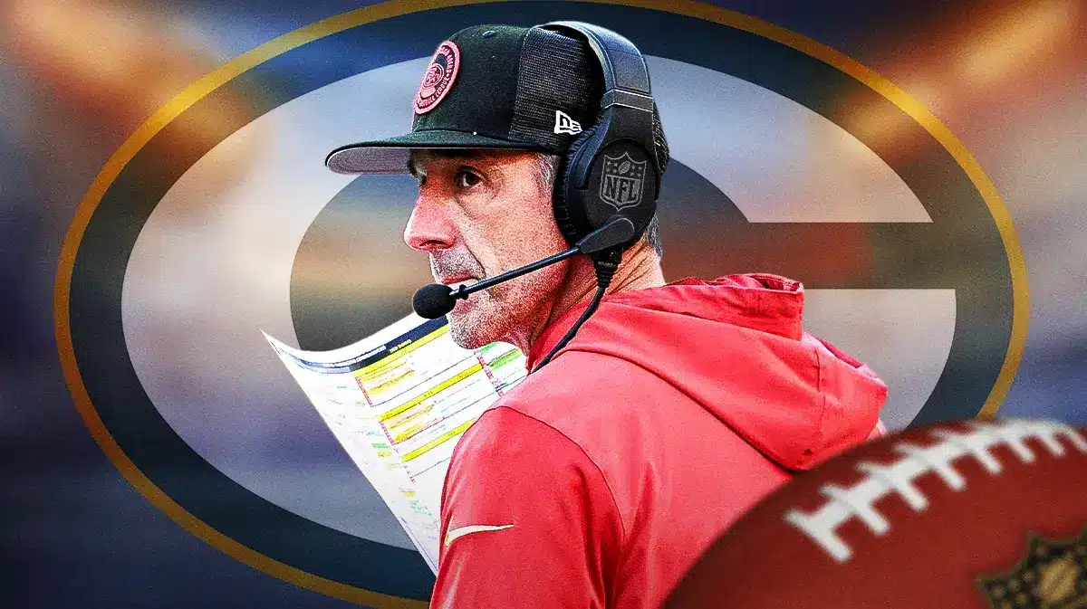 Photo: Kyle Shanahan with playbook with Packers logo in the back
