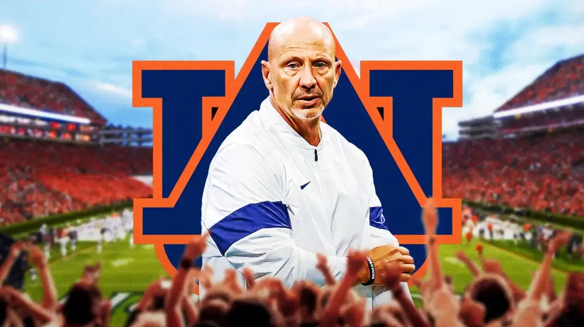 Photo: Charles Kelly in Auburn gear with AU logo behind him