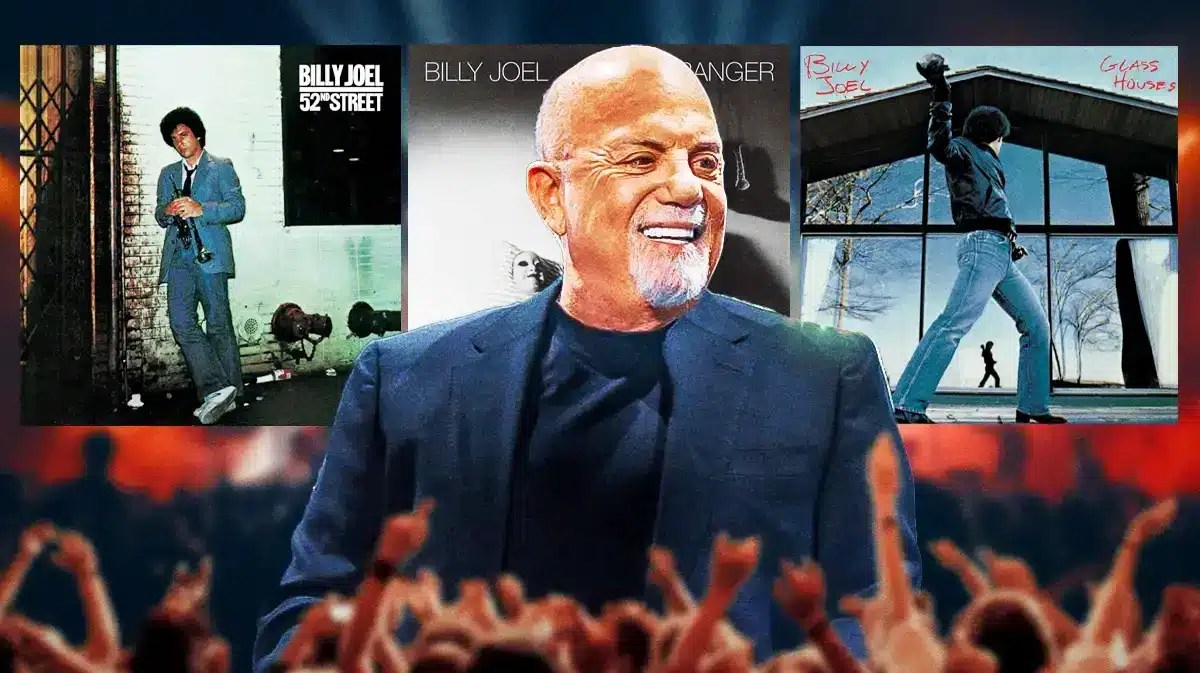Billy Joel in front of 52nd Street, The Stranger, and Glass Houses album covers.
