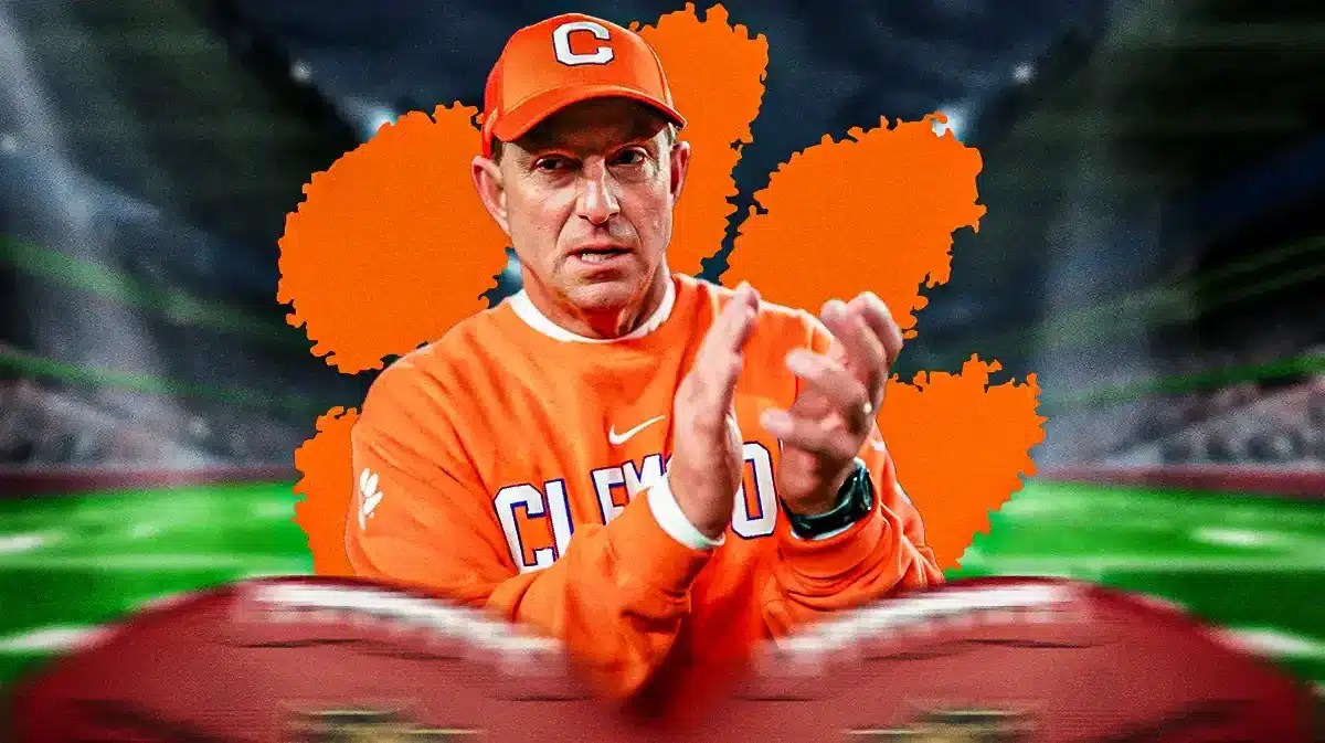 Photo: Dabo Swinney in Clemson gear with Clemson logo behind him