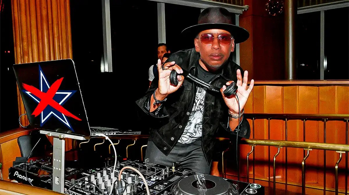 Stephen A. Smith as a DJ, with Cowboys logo on laptop