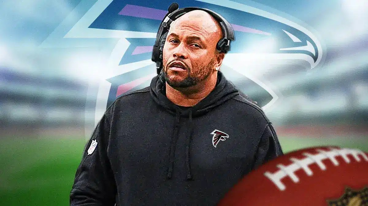 Photo: Antonio Pierce in Falcons gear with Falcons logo behind him