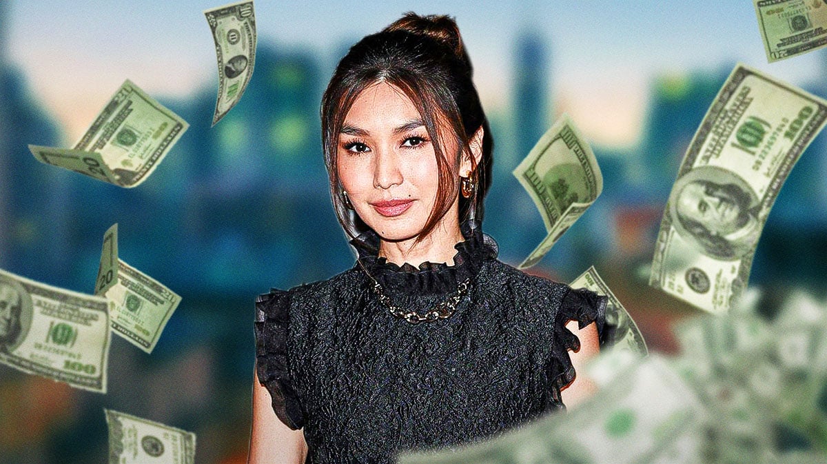 Gemma Chan surrounded by piles of cash.