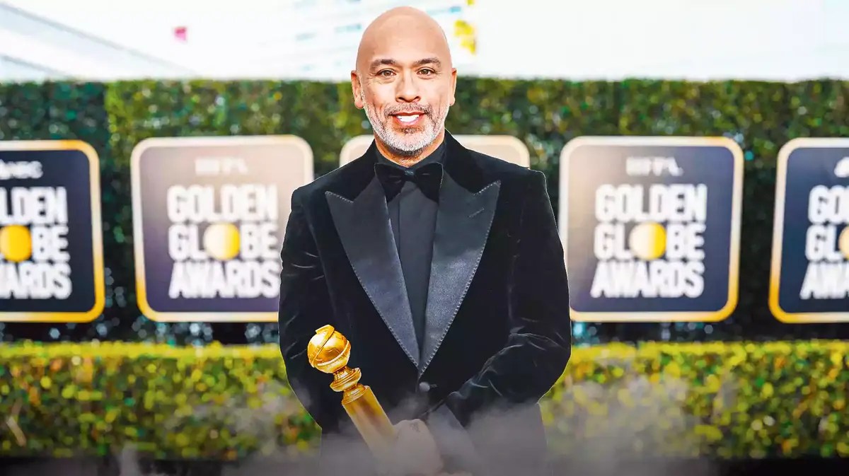Jo Koy holding a Golden Globe award.