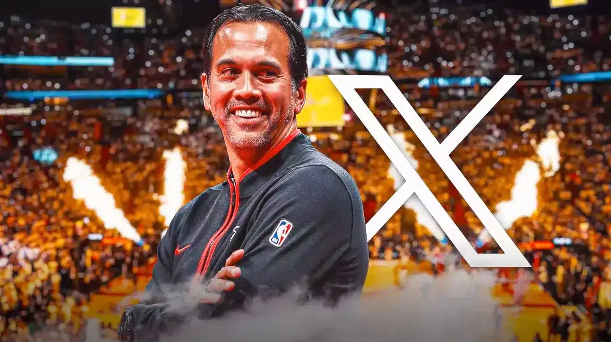 Miami Heat head coach Erik Spoelstra smiling with giant X (twitter) icon in the background