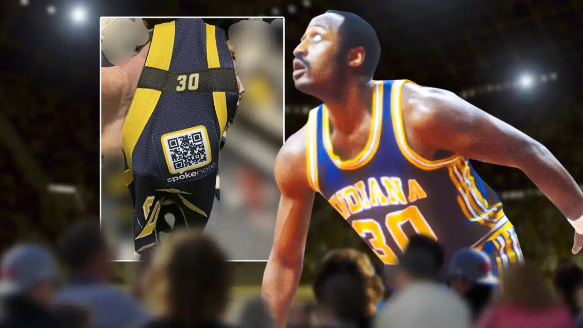 George McGinnis from his playing days in his Pacers jersey with a screenshot of the image from the link in the background