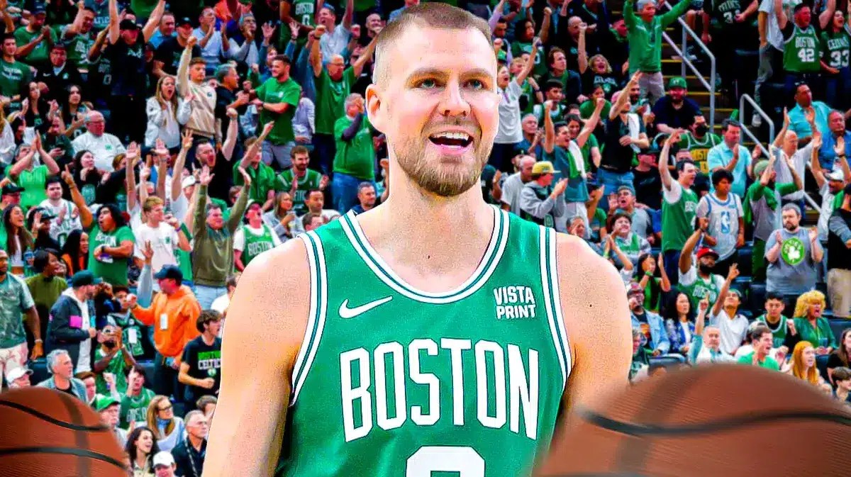 Kristaps Porzingis smiling with a bunch of Celtics fans around him