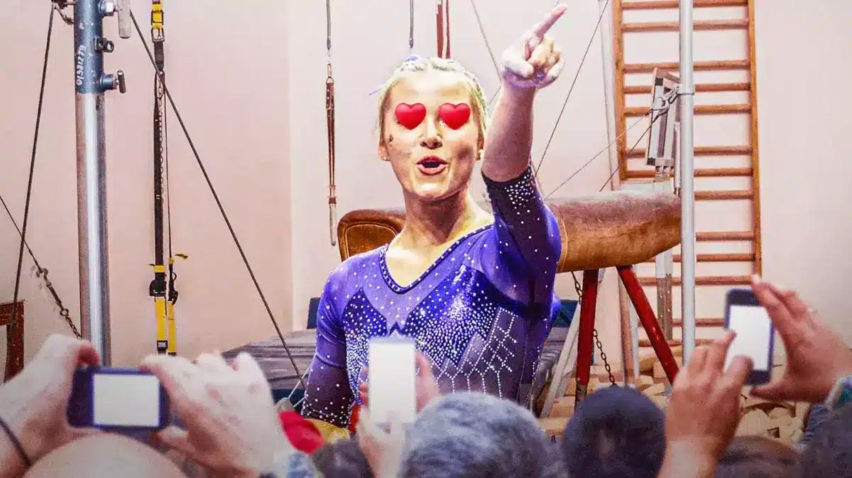LSU gymnast Olivia Dunn in her gymnastics uniform, with hearts in her eyes, as if she is in a gym with different gymnastics equipment around her