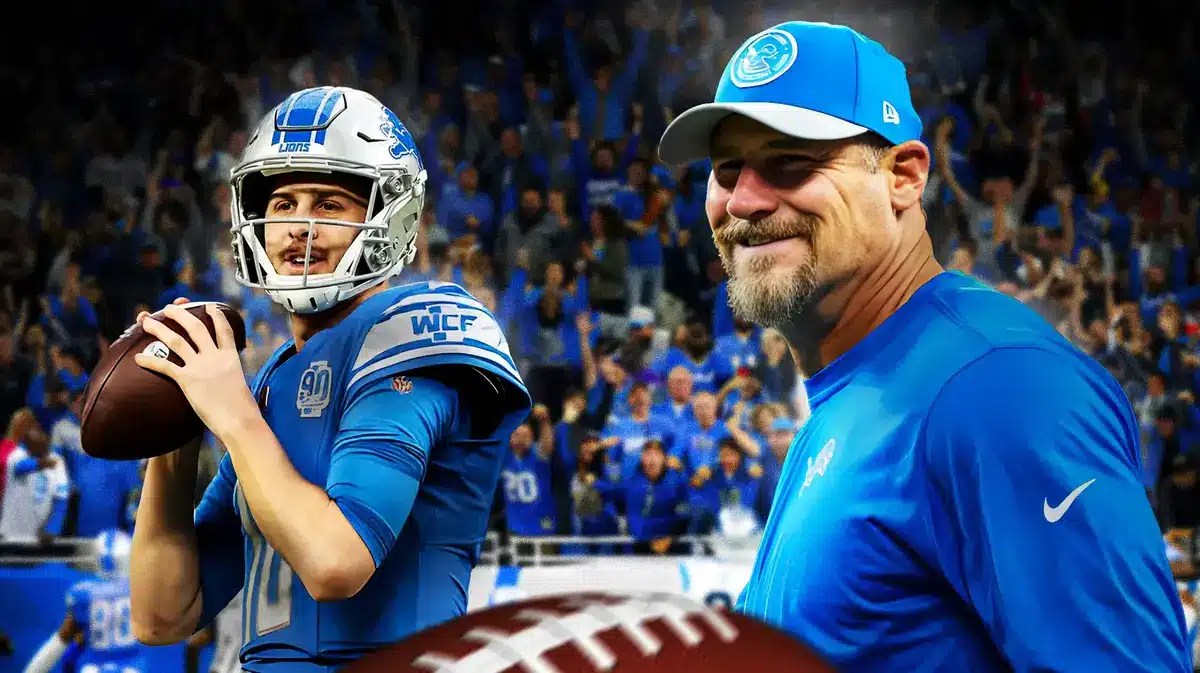 Detroit Lions QB Jared Goff beside head coach Dan Campbell. Lions crowd cheering at the back
