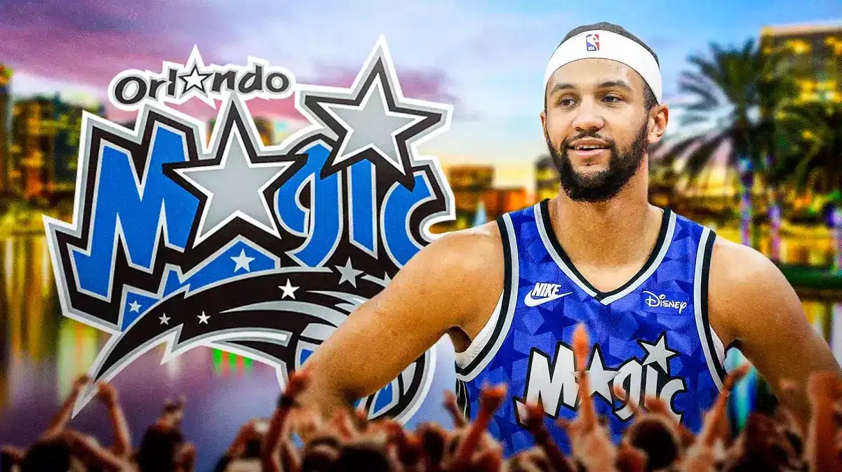 Photo: Jalen Suggs in Magic uniform with Magic logo in the background