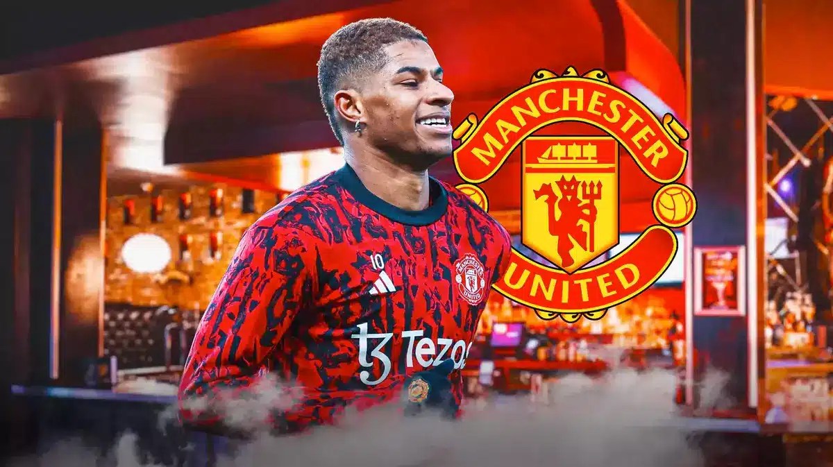 Marcus Rashford in a nightclub, the Manchester United logo behind on the wall