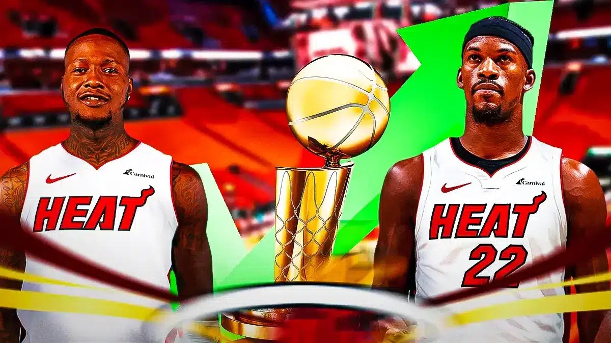 Heat players Jimmy Butler and Terry Rozier with an NBA Finals trophy.
