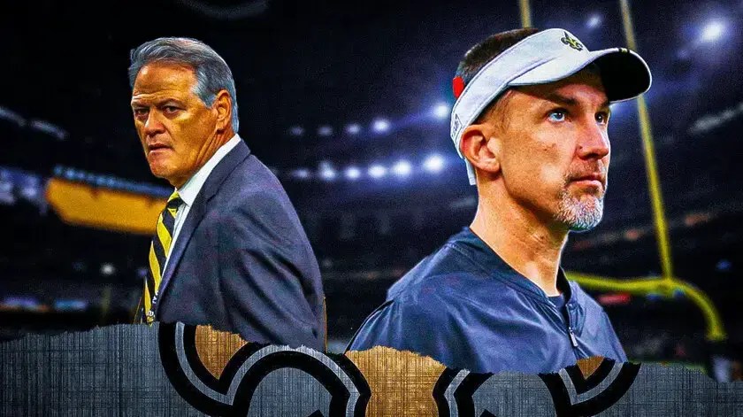 Photo: Dennis Allen in Saints gear with Mickey Loomis and Saints logo in the back