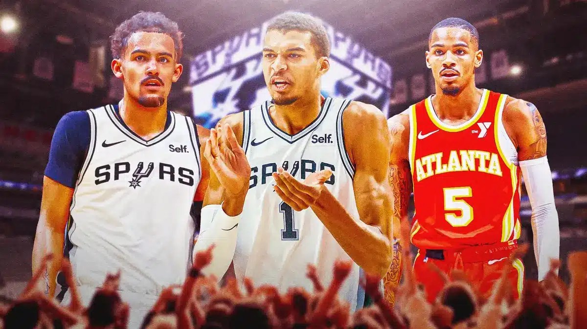 Spurs' Victor Wembanyama hyped up, with Trae Young in a Spurs uni beside him, Dejounte Murray looking on in Hawks uni