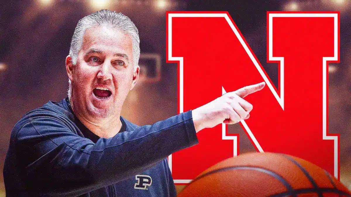 Photo: Matt Painter in Purdue gear with Nebraska logo behind him