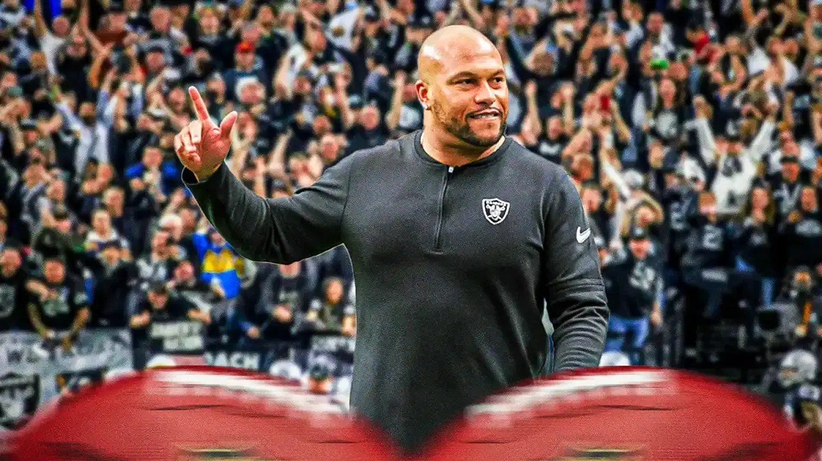 Photo: Antonio Pierce in Raiders gear with fans chanting behind him