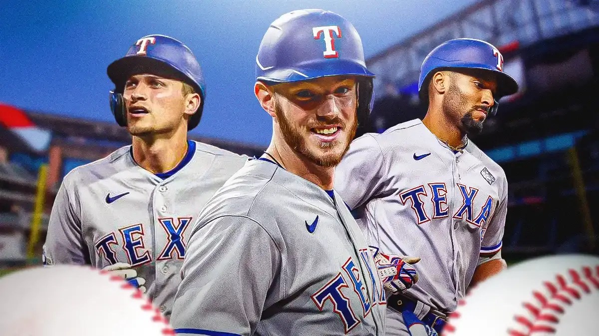 Rangers' Jonah Heim in front. Rangers' Corey Seager, Rangers' Marcus Semien in background.