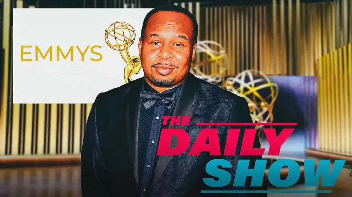 Roy Wood Jr. on stage, The Daily Show logo in the foreground, the Emmys logo in the background