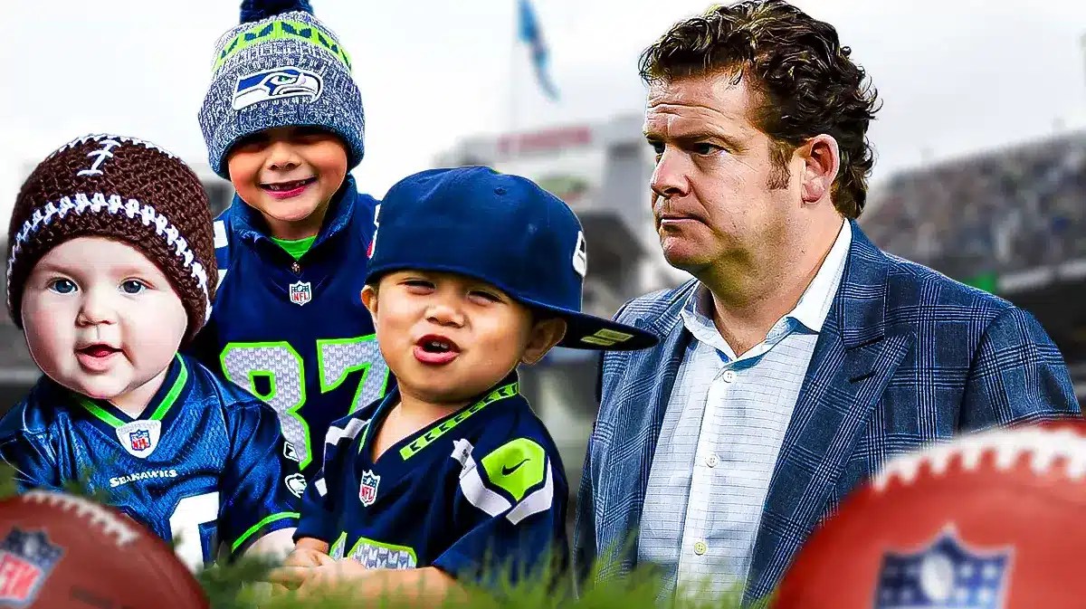 Seahawks GM John Schneider next to babies in Seahawks uniforms