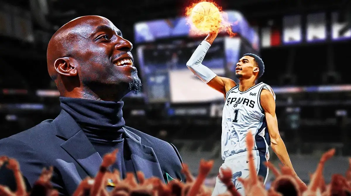 Spurs' Victor Wembanyama dunking a basketball. Place fire on the basketball. Kevin Garnett watching Wembanyama dunk the ball.