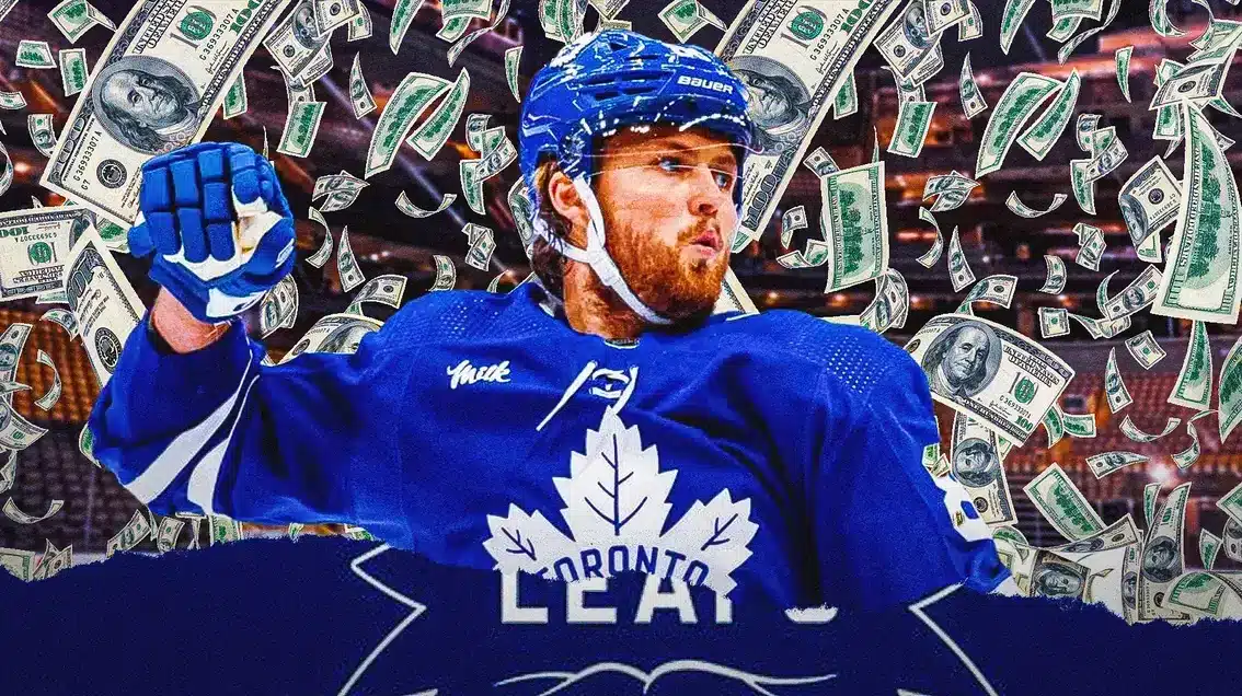 William Nylander in middle of image looking happy, money all around him, TOR Maple Leafs logo, hockey rink in background
