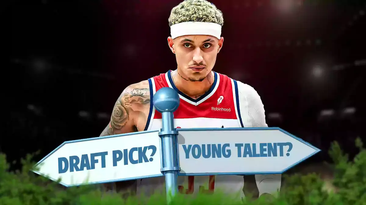 Kyle Kuzma with a sign that says "Draft picks?" and "Young talent?"