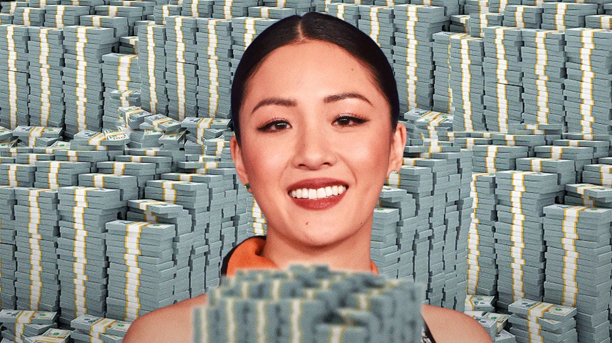 Constance Wu surrounded by piles of cash.