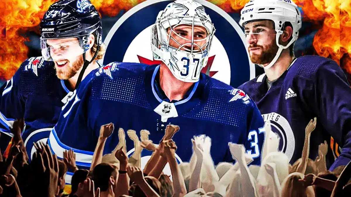 Connor Hellebuyck in middle, Nikolaj Ehlers on one side, Gabriel Vilardi on other side, fire all in image, Winnipeg Jets logo, hockey rink in background