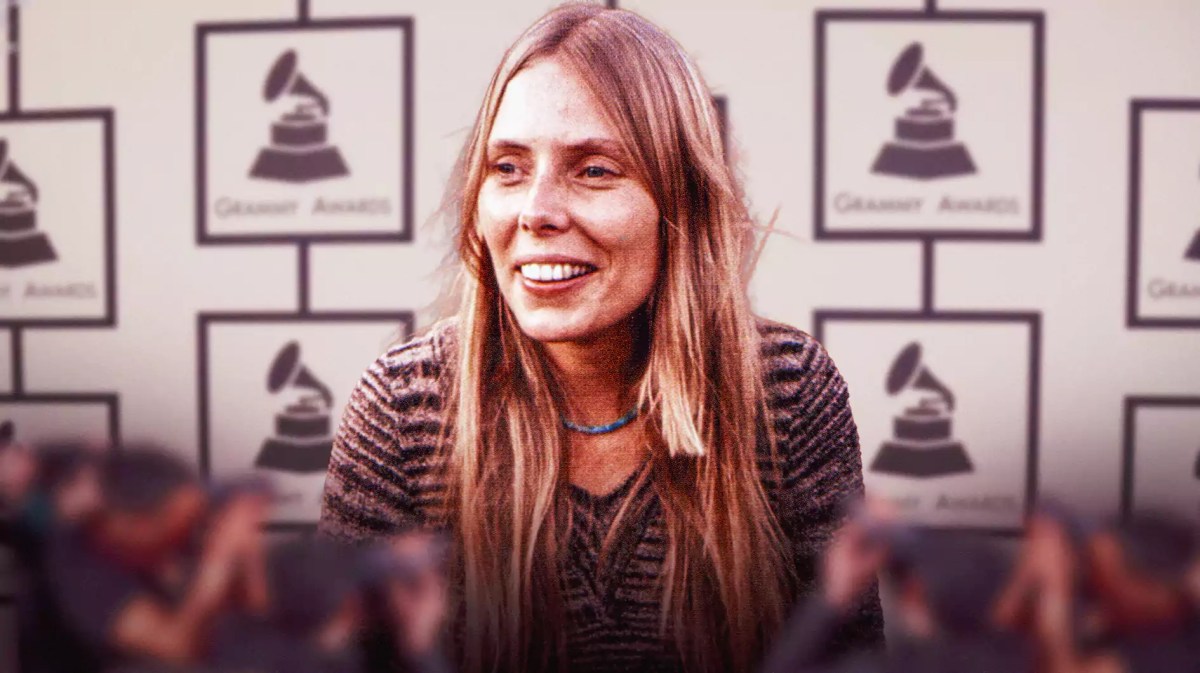 Joni Mitchell with Grammys in background.