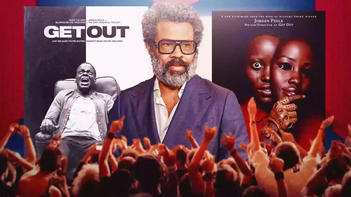 Jordan Peele between posters of Get Out and Us.