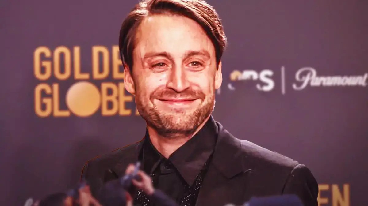 Kieran Culkin with Golden Globes set behind him.