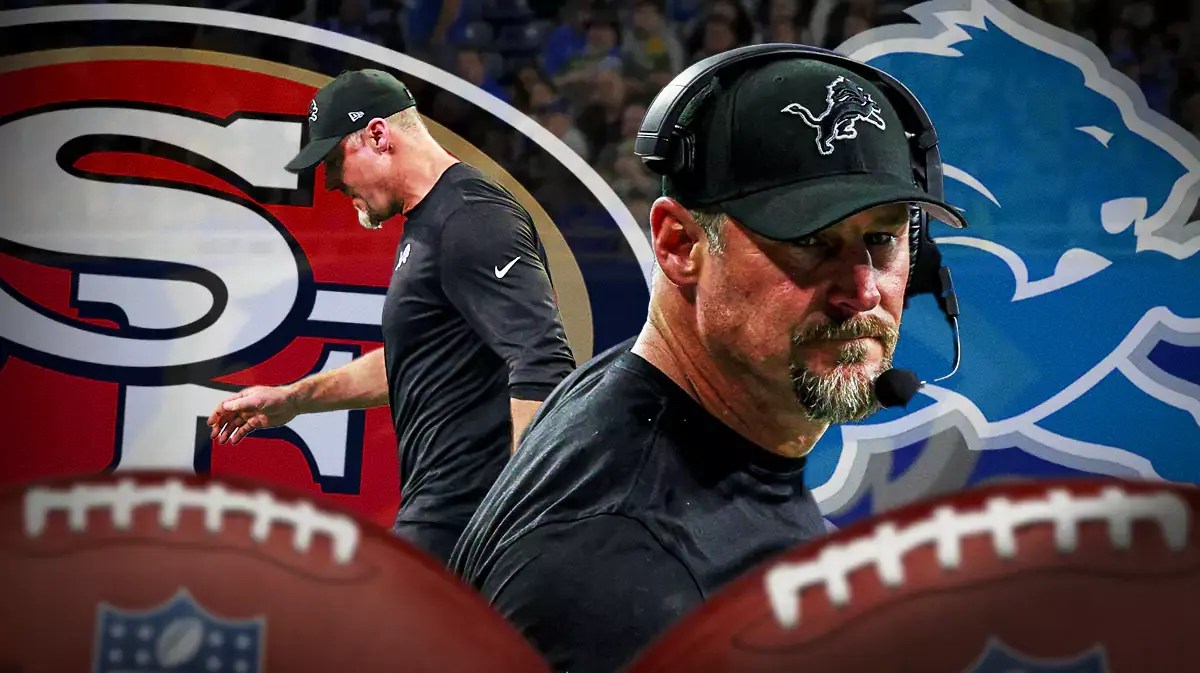 Photo: Dan Campbell in Lions gear with Lions logo and 49ers logo behind him