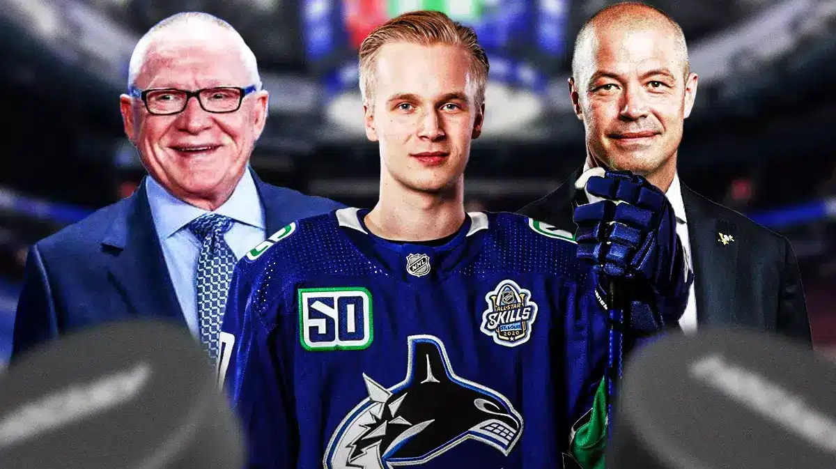 Elias Pettersson in middle looking happy, Patrik Allvin and Jim Rutherford on either side, VAN Canucks logo, hockey rink in background