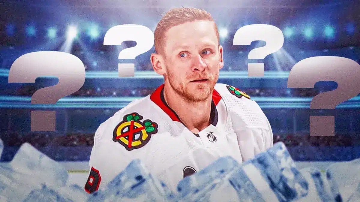 Corey Perry in middle of image looking stern, hockey rink in background, a few question marks in image