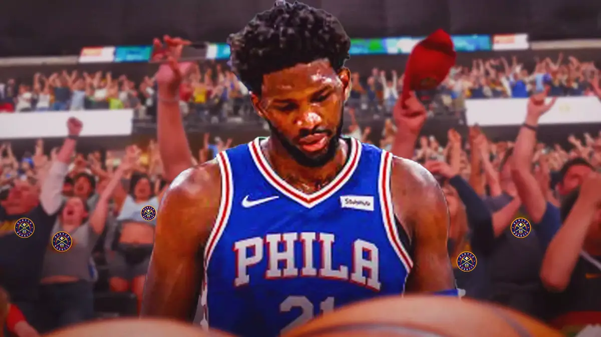 Joel Embiid with fans with Nuggets logo booing in the background