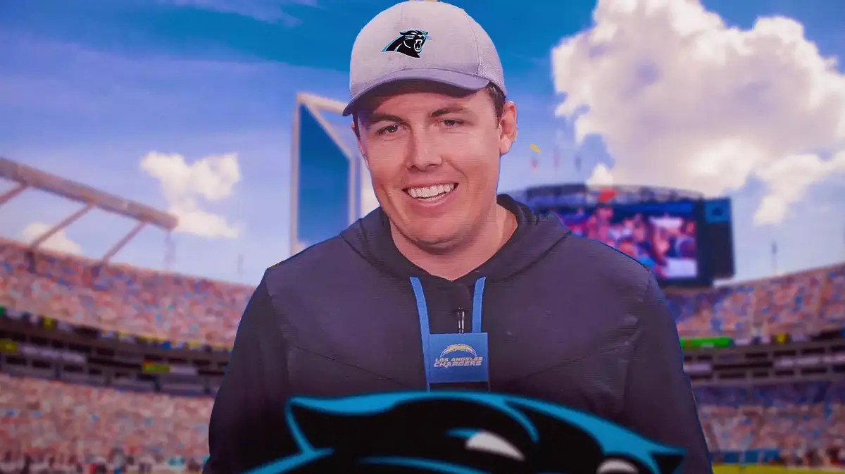 Kellen Moore in a Carolina Panthers hat