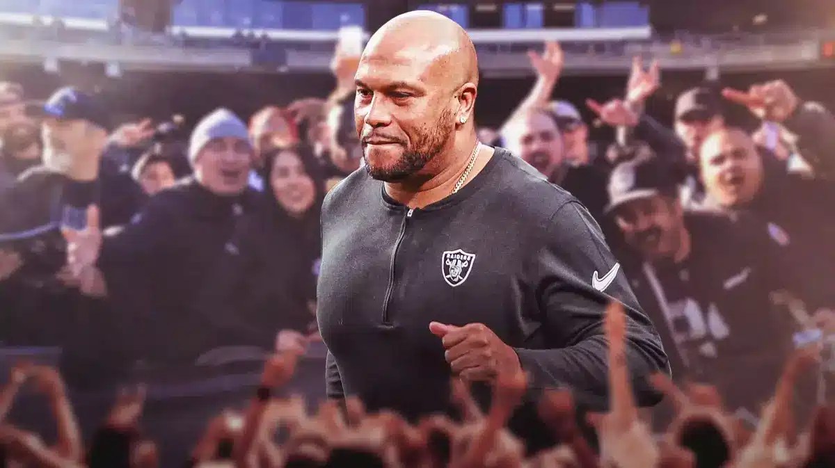 Las Vegas Raiders coach Antonio Pierce and Raiders fans looking happy/cheering around him.