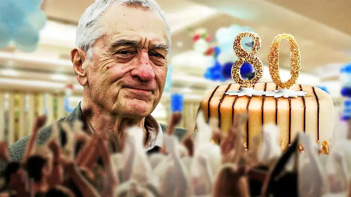 Robert De Niro with a birthday cake that says 80.