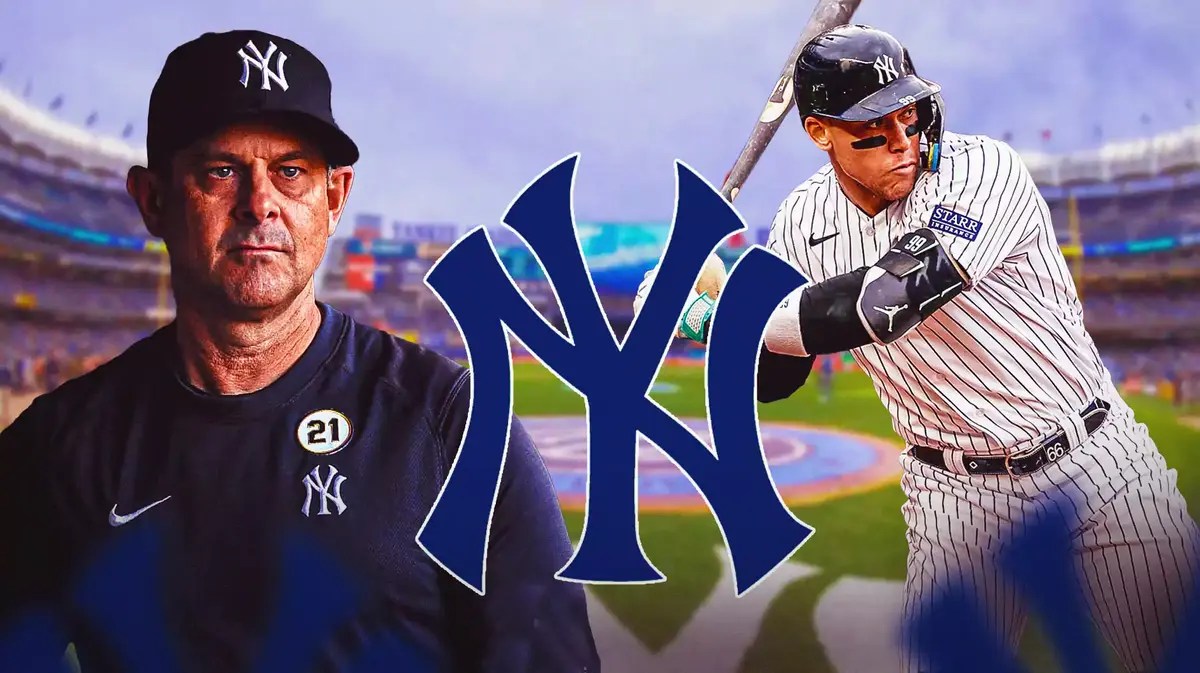 Aaron Boone and Aaron Judge swinging a bat next to a Yankees logo at Yankee Stadium