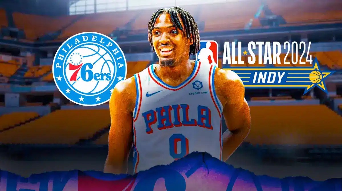 76ers' Tyrese Maxey smiles next to NBA All-Star Game logo before Pacers' Tyrese Haliburton takes the floor