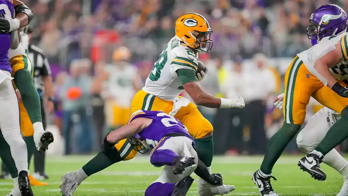 Green Bay Packers running back AJ Dillon (28) runs with the ball against the Minnesota Vikings in the third quarter at U.S. Bank Stadium.