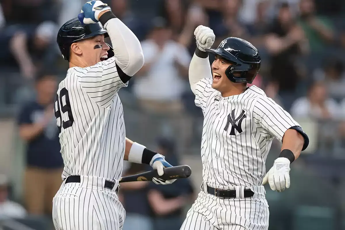 New York Yankees shortstop Anthony Volpe (11) celebrates his solo home run with right fielder Aaron Judge (99) during the first inning against the Minnesota Twins at Yankee Stadium