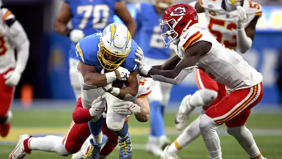 Los Angeles Chargers running back Austin Ekeler (30) is tackled by Kansas City Chiefs linebacker Jack Cochrane (43) and cornerback Joshua Williams (2) during the second half at SoFi Stadium
