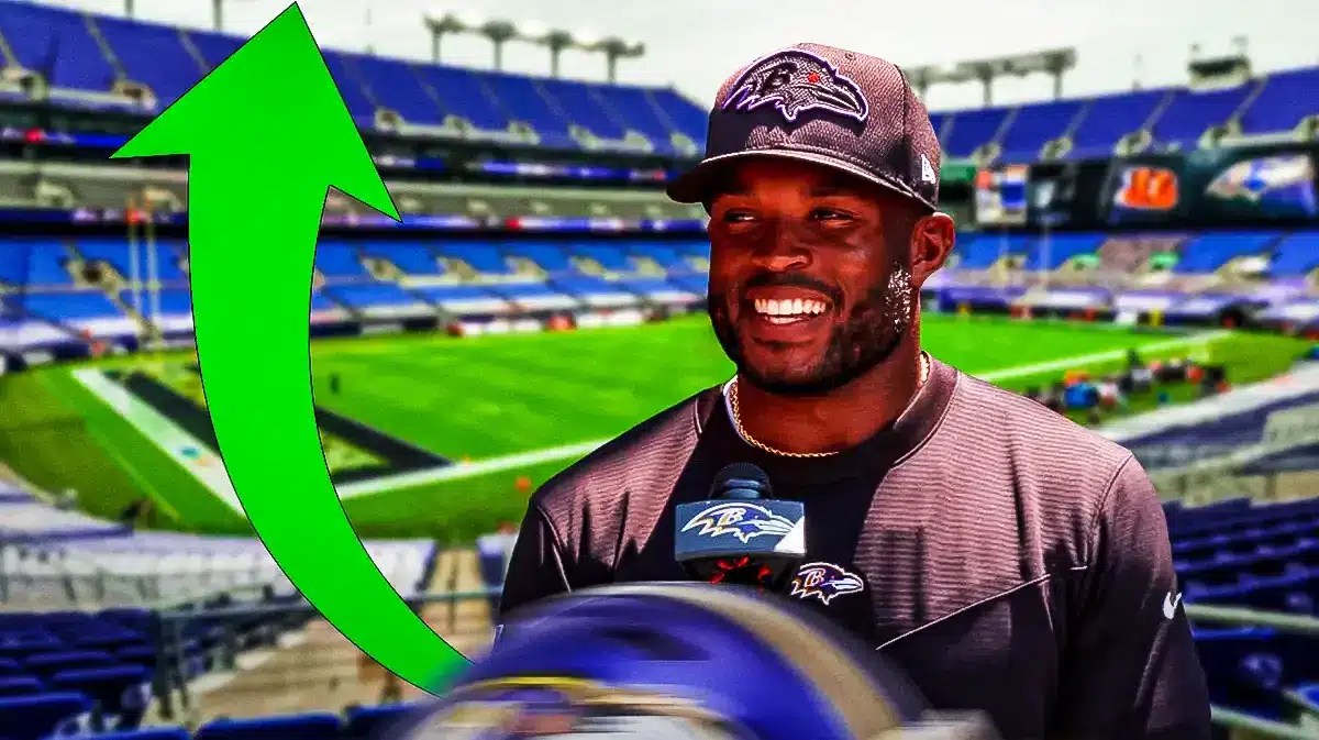 Ravens coach Zach Orr with a green up arrow next to him.