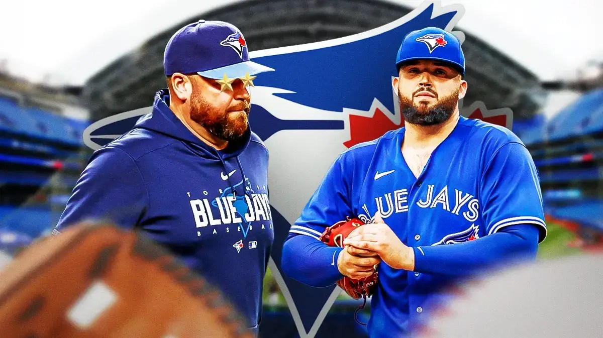 John Schneider with stars in his eyes looking at Alek Manoah in front of a Blue Jays logo