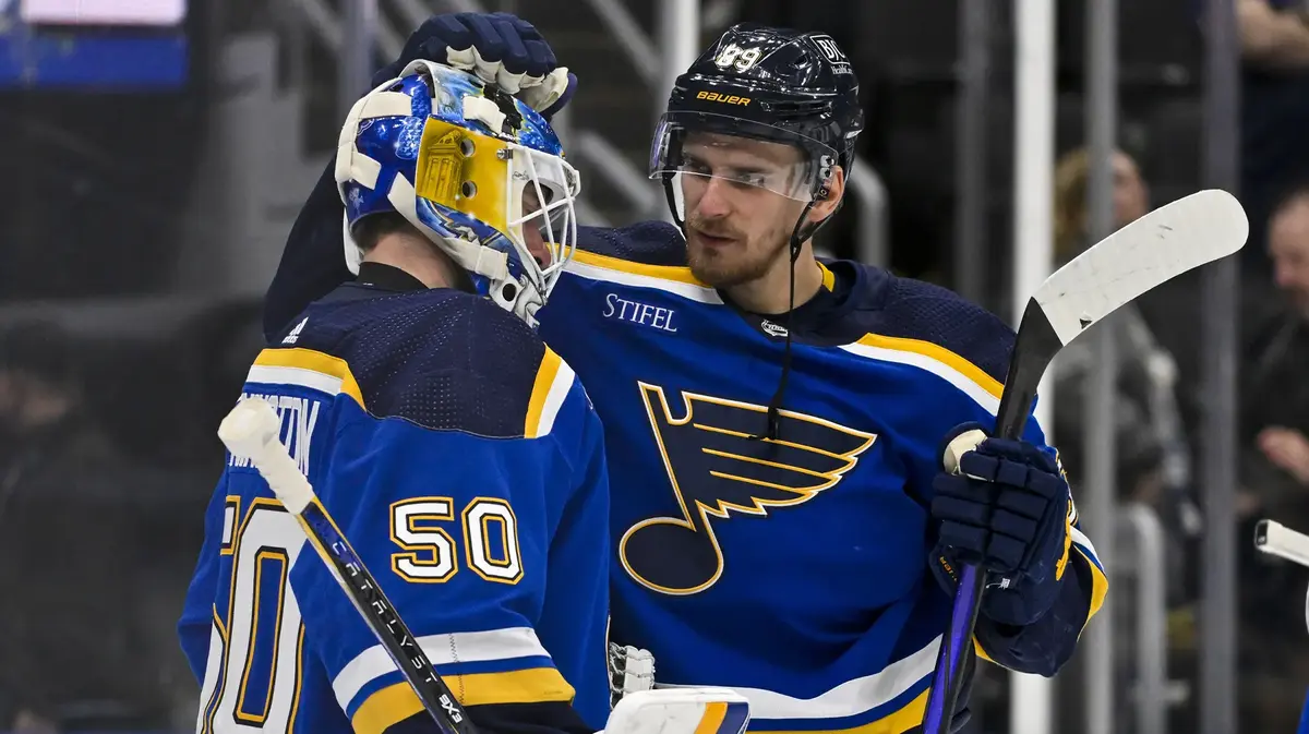 St. Louis Blues left wing Pavel Buchnevich (89) and goaltender Jordan Binnington (50) celebrate after the Blues defeated the New York Islanders at Enterprise Center.